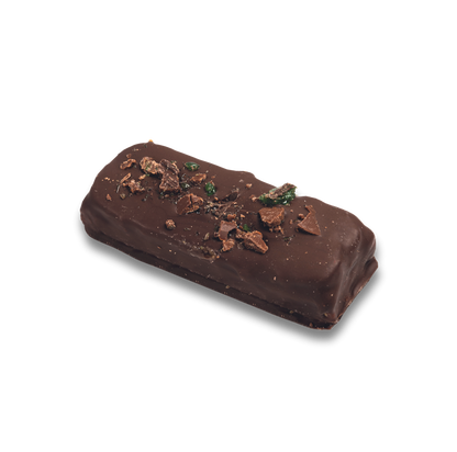 a chocolate covered rectangular object with pieces of chocolate on top